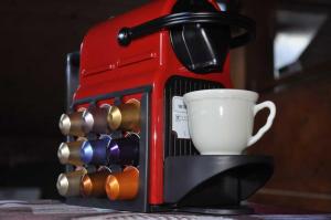 a coffee maker with a cup on a table at Appartement Les Arolles in Chamonix