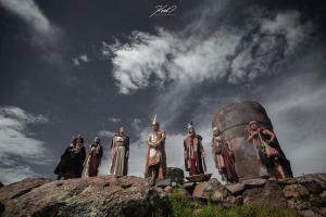 a group of people standing on top of a monument at Lake HOME in Puno