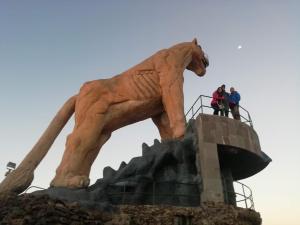 people standing on top of a statue of a horse at Lake HOME in Puno