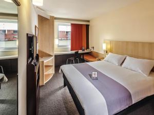 a hotel room with a large bed and a television at Ibis Praha Old Town in Prague +93 photos