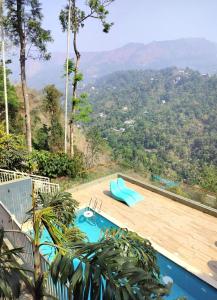 a swimming pool with a view of the mountains at British County Resorts in Anachal