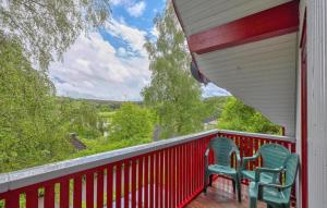 two chairs sitting on the porch of a house at Maier Kirchheim in Kemmerode +19 photos