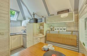 a kitchen with a wooden table with cups on it at Maier Kirchheim in Kemmerode