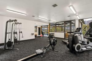 a gym with several treadmills and exercise bikes at Luxuy Vista in Wanaka