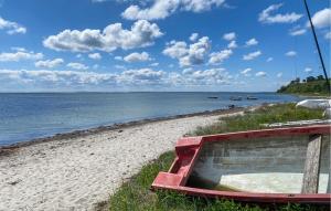 a boat sitting on the shore of a beach at Gorgeous Home In Hundested With Wifi in Hundested