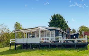 a tiny house on a dock in the grass at Gorgeous Home In Hundested With Wifi in Hundested +11 photos