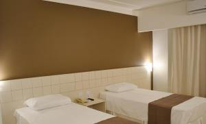 Giường trong phòng chung tại Villa Premium Hotel
