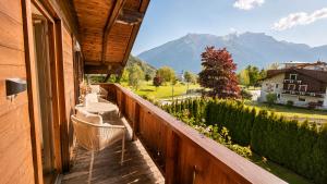 a balcony with chairs and a view of a mountain at Michelis Cottage - Achensee in Pertisau +30 photos