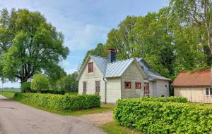 a small white house with a chimney on a road at Paulinas Hus in Laholm +13 photos