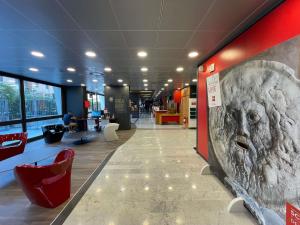 a hallway of a building with a face on the wall at Ibis Roma Fiera in Rome