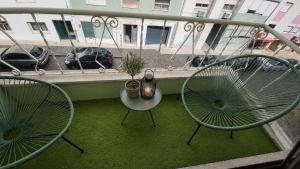 two chairs and a table on a balcony at Odivelas Home in Odivelas