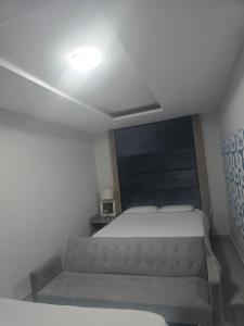 a small bedroom with a bed and a light on the ceiling at Co operville in Potchefstroom