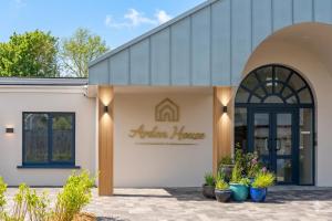 a building with a sign that reads autism house at Arden House in Dingle