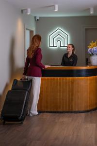 a woman standing at a counter with a man at Arden House in Dingle