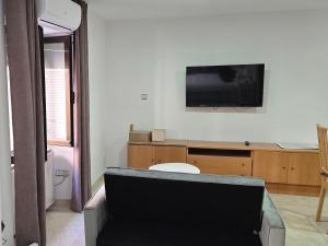 a living room with a flat screen tv on the wall at apto La Campana in Toledo