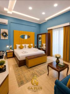 a bedroom with a king sized bed and a living room at GA Cairo Hotel Downtown in Cairo