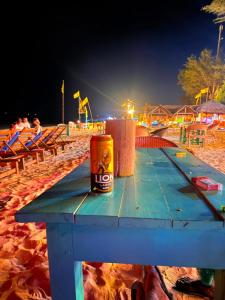 a can of beer sitting on a picnic table on the beach at Vitamin sea beach cabana in Nilaveli