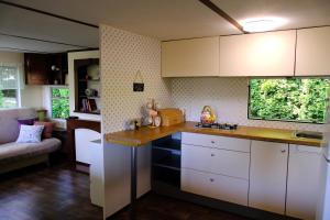 a kitchen with white cabinets and a counter top at Kalva Sumowo in Sumowo +18 photos