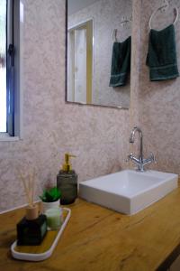 a bathroom with a white sink and a mirror at Kalva Sumowo in Sumowo