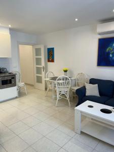 a living room with a couch and a table and chairs at Anna Apartment in Altea