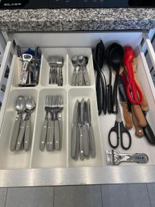a drawer filled with lots of utensils at Anna Apartment in Altea +38 photos