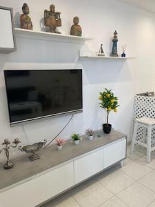 a living room with a large flat screen tv on a wall at Anna Apartment in Altea