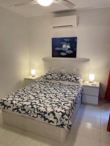 a bedroom with a bed and two night stands at Anna Apartment in Altea
