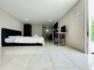 a bedroom with a bed and a tiled floor at Balcony Garden Studio in Johor Bahru