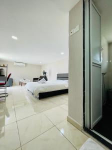 a bedroom with a bed and a glass wall at Balcony Garden Studio in Johor Bahru