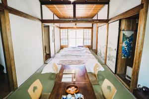 a long room with a long table and chairs at Tipy records inn house in Odawara +88 photos