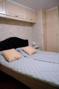 a bed with two pillows on it in a room at Kalva Sumowo in Sumowo