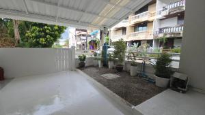 a courtyard with potted plants in a building at Chillax Townhome 65 in Hua Hin