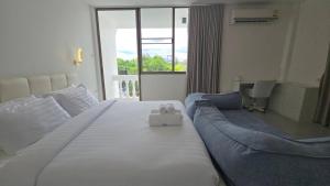 a hotel room with a bed with two teddy bears on it at Chillax Townhome 65 in Hua Hin