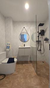 a bathroom with a tub and a sink and a mirror at Chillax Townhome 65 in Hua Hin +20 photos