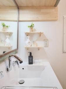 a bathroom with a sink and a mirror at Dearcourt Kichijoji 1F-3F in Musashino +62 photos