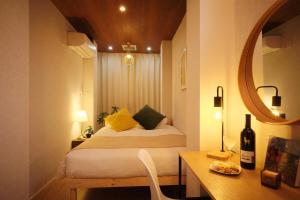 a bedroom with a bed with a mirror and a table at Dearcourt Kichijoji 1F-3F in Musashino