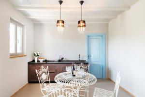 a dining room with a table and chairs at L'Attico di Asilo in Barolo in Barolo