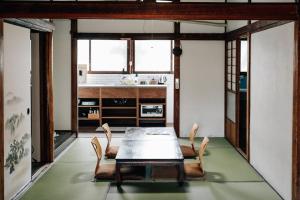 a dining room with a table and chairs at Tipy records inn house in Odawara