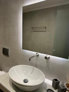 a white sink in a bathroom with a mirror at K&L Luxury Suite 2 in Parga +12 photos
