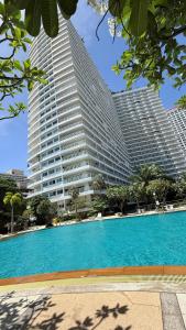 a large building with a swimming pool in front of it at View Talay Condominium by Vlad Property in Pattaya South