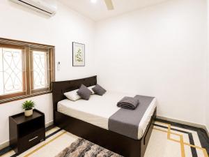 a bedroom with a bed in a white room at DNN Brothers Villa in Jaffna