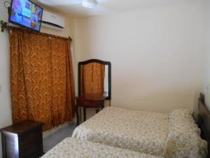 Postel nebo postele na pokoji v ubytování Hotel Quinta San Juan