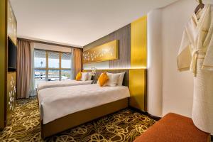 a hotel room with two beds and a window at Sama-Sama Express KLIA Terminal 1 - Airside Transit Hotel in Sepang