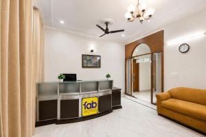 an office with a reception desk and a couch at FabHotel The Arjun Sushant lok - Iffco Chowk Sector 29 in Gurgaon +29 photos