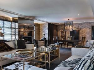 a living room with a couch and a table at Sofitel Queenstown Hotel & Spa in Queenstown