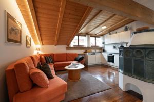 a living room with a couch and a kitchen at Apartments Rezia in Ortisei