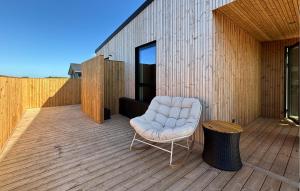 a white chair sitting on a wooden deck at Gorgeous Home In Haderslev With Sauna in Haderslev