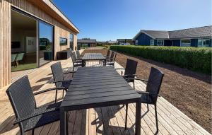 a wooden table and chairs on a deck at Gorgeous Home In Haderslev With Sauna in Haderslev +17 photos