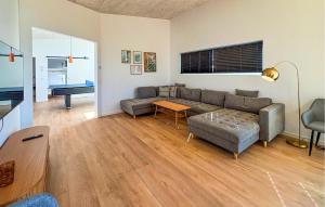 a living room with a couch and a table at Gorgeous Home In Haderslev With Sauna in Haderslev