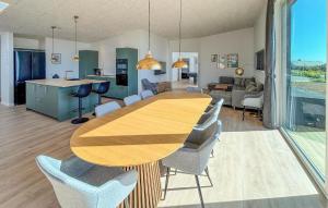 a dining room and kitchen with a wooden table and chairs at Gorgeous Home In Haderslev With Sauna in Haderslev